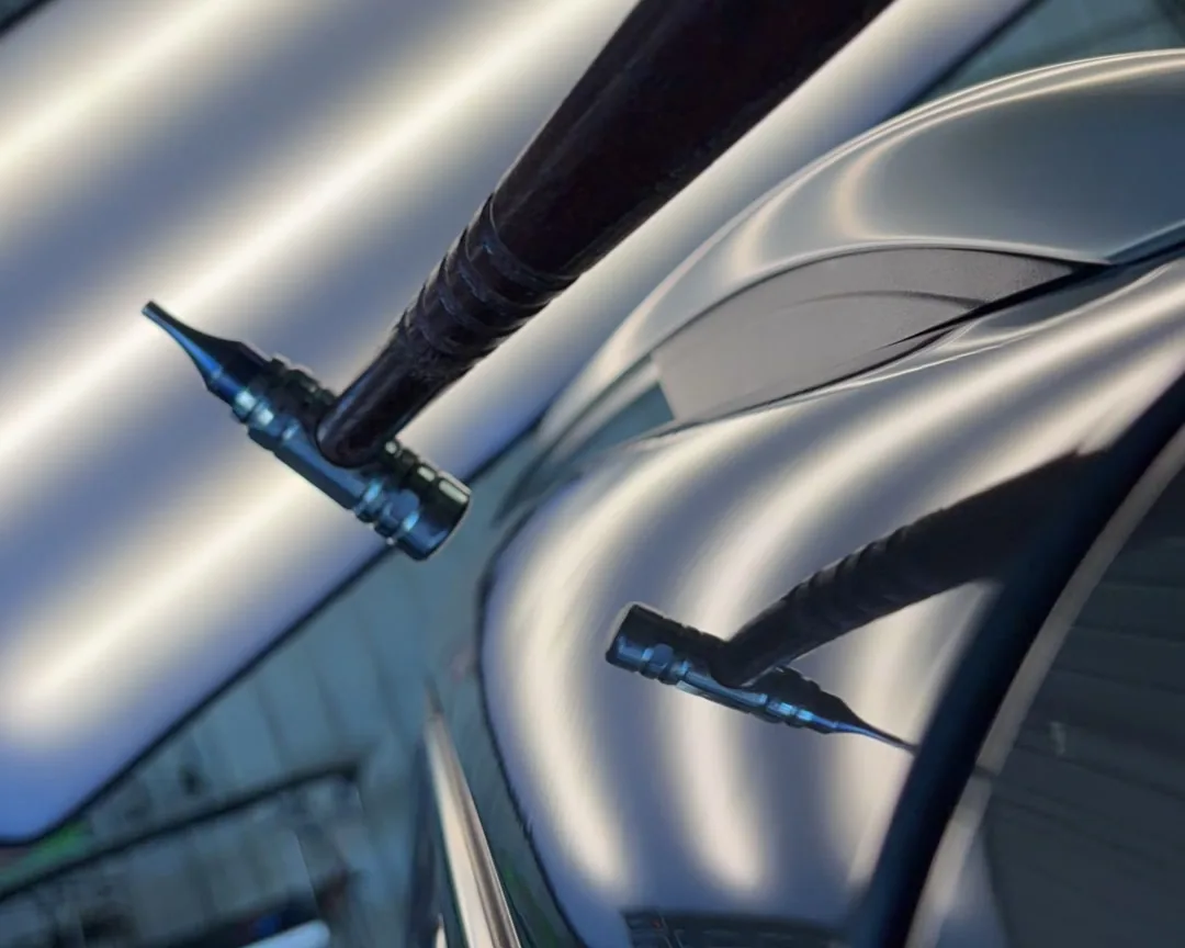 Two PDR rod tips at a silver panel, lit by the stripes of a reflection board